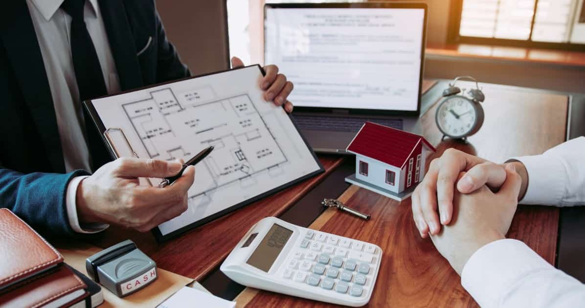 Agents using pens to point at a home blueprint.