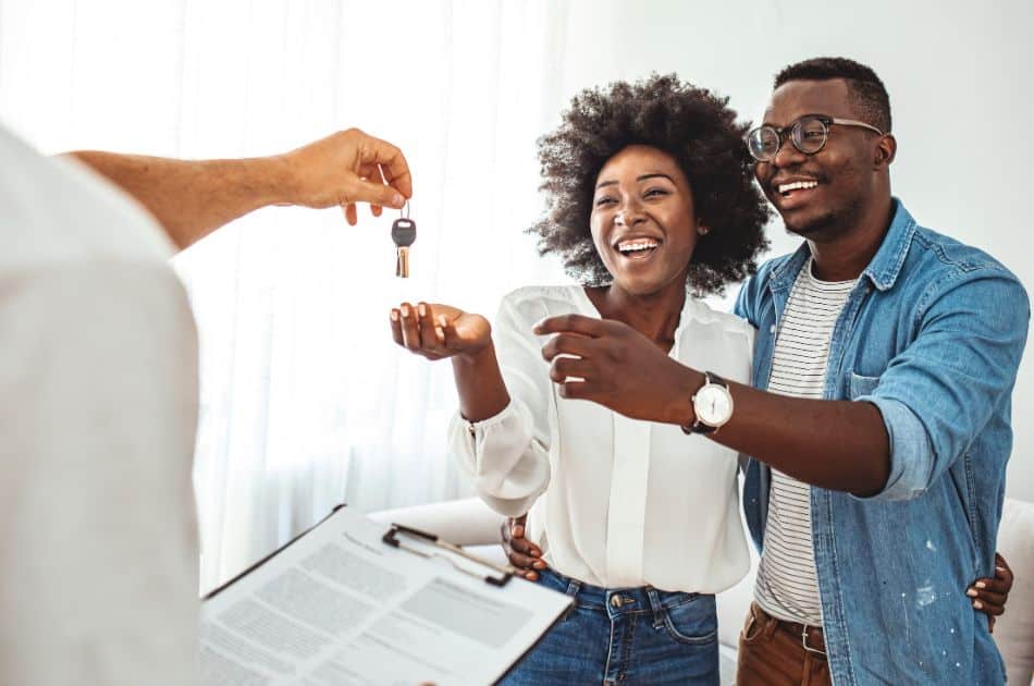 couple getting keys from real estate agent